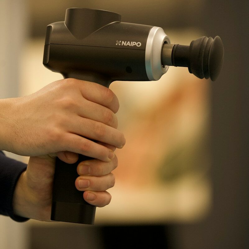 person holding black and gray cordless hand drill