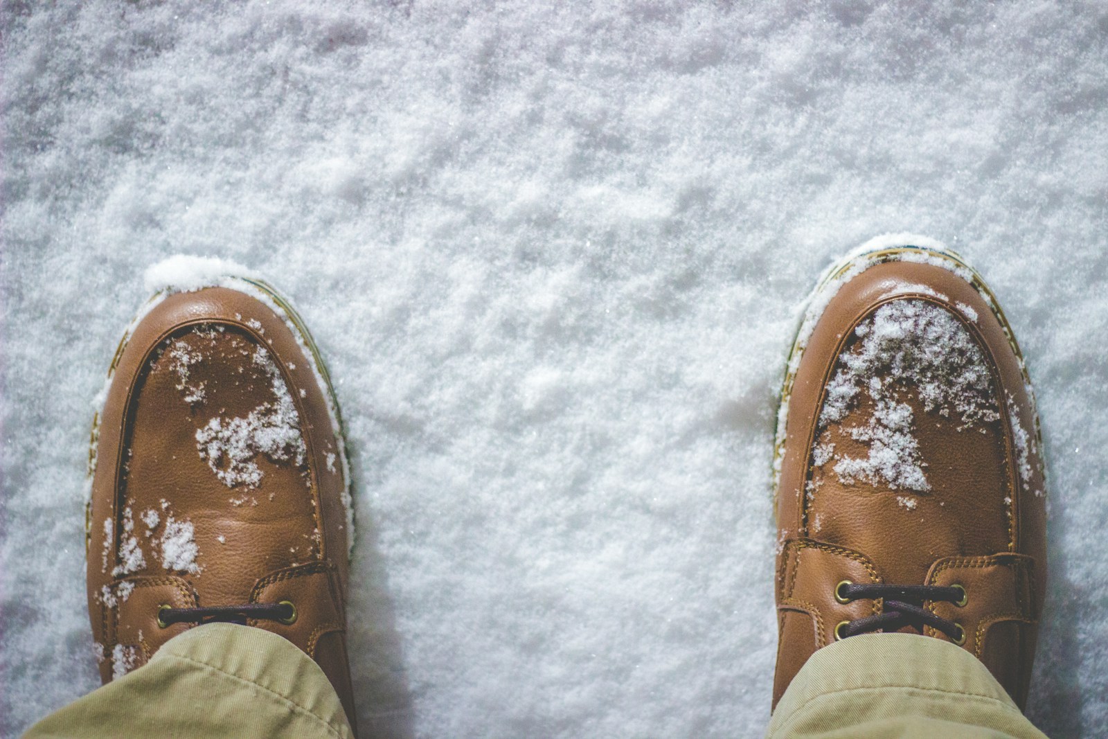 top view photography of person standing on snow covered field